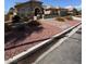 Street view of home featuring desert landscaping with brick walkway at 5005 Wild Thyme Ave, Las Vegas, NV 89131