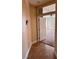 Hallway leads to a bedroom with a white door and tan tile flooring at 5005 Wild Thyme Ave, Las Vegas, NV 89131