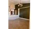 Living room featuring tan tile floor, dark green accent wall, and chandelier at 5005 Wild Thyme Ave, Las Vegas, NV 89131