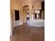 Living room featuring a tan tile floor, arched doorways, and dark wood trim at 5005 Wild Thyme Ave, Las Vegas, NV 89131