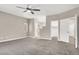 A generously sized bedroom featuring neutral walls, plush carpeting, a ceiling fan, and ensuite bathroom and closet at 531 Coolidge Ave, Henderson, NV 89015