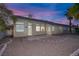 View of a gravel backyard with block wall, mature trees, and desert landscaping at 5512 Goldbrush St, Las Vegas, NV 89130