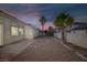 Spacious backyard with gravel, palm trees and brick accents offering great outdoor living at 5512 Goldbrush St, Las Vegas, NV 89130