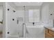 A bright bathroom features a walk-in shower and a modern soaking tub at 5512 Goldbrush St, Las Vegas, NV 89130
