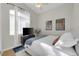 Bright bedroom with white curtains, a TV and two cityscape prints on the wall at 5512 Goldbrush St, Las Vegas, NV 89130