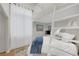 Bright bedroom with white ladder for loft access and large window with white curtains at 5512 Goldbrush St, Las Vegas, NV 89130