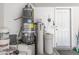 Garage area featuring a water heater, water softener, and storage buckets at 5512 Goldbrush St, Las Vegas, NV 89130
