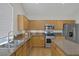 Stylish kitchen with stainless steel appliances, wood cabinets, and granite countertops at 5512 Goldbrush St, Las Vegas, NV 89130