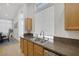 Bright kitchen with stainless steel sink, natural wood cabinets, and granite countertops at 5512 Goldbrush St, Las Vegas, NV 89130