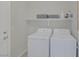 Cozy laundry room with white appliances and a shelf for storage at 5512 Goldbrush St, Las Vegas, NV 89130