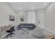 Well-lit living room with comfortable seating, a desk, and modern decor at 5512 Goldbrush St, Las Vegas, NV 89130