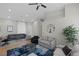 Spacious living area with comfortable seating, complemented by a stylish round mirror at 5512 Goldbrush St, Las Vegas, NV 89130