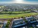 An aerial view of the condo community and golf course with mountain views in the distance on a sunny day at 5655 E Sahara Ave # 1053, Las Vegas, NV 89142