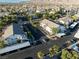 The aerial view shows the well-maintained condo community with palm trees, covered parking and mountain views in the distance at 5655 E Sahara Ave # 1053, Las Vegas, NV 89142