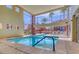 Indoor swimming pool offering natural light and providing views of the outdoor community spaces and palm trees at 63 E Agate Ave # 202, Las Vegas, NV 89123