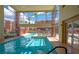 Indoor swimming pool offering natural light and providing views of the outdoor community spaces and palm trees at 63 E Agate Ave # 202, Las Vegas, NV 89123
