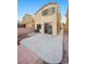 Backyard featuring a concrete patio, brick wall, and sliding glass door at 6460 Raven Hall St, North Las Vegas, NV 89084