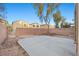 Backyard featuring a concrete patio, brick wall, and some landscaping at 6460 Raven Hall St, North Las Vegas, NV 89084