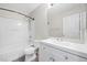 Full bathroom with white vanity, ample lighting, and shower-tub combo at 6460 Raven Hall St, North Las Vegas, NV 89084