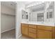 Primary bathroom features a double vanity, large mirror, and walk-in closet at 6460 Raven Hall St, North Las Vegas, NV 89084