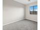 Bedroom with a window view with neutral carpet and walls provides a blank canvas for personalization at 6460 Raven Hall St, North Las Vegas, NV 89084