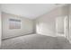Clean, bright bedroom with neutral walls, carpet and natural light, perfect for relaxation at 6460 Raven Hall St, North Las Vegas, NV 89084