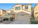 Desirable two-story home featuring a two-car garage, neutral paint, and tidy landscaping for curb appeal at 6460 Raven Hall St, North Las Vegas, NV 89084