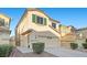 Inviting two-story home with a well-maintained front yard, a two-car garage and a cozy exterior at 6460 Raven Hall St, North Las Vegas, NV 89084