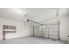 Clean, empty two car garage featuring ample space and an automatic door opener at 6460 Raven Hall St, North Las Vegas, NV 89084