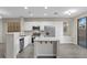 Bright, modern kitchen with stainless steel appliances, white cabinets, and a functional island with seating at 6460 Raven Hall St, North Las Vegas, NV 89084