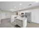 Modern open-concept kitchen featuring stainless steel appliances, island seating, and seamless flow to living areas at 6460 Raven Hall St, North Las Vegas, NV 89084
