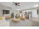 Cozy living room with modern decor, featuring an open floor plan flowing into a bright kitchen and dining area at 6460 Raven Hall St, North Las Vegas, NV 89084
