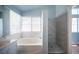 A bright bathroom showcases a soaking tub and a separate tiled shower at 6524 Rain Forest Dr, Las Vegas, NV 89108