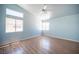 This bedroom features wood-look floors, vaulted ceilings, and a windows for ample natural light at 6524 Rain Forest Dr, Las Vegas, NV 89108