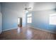 This bedroom features wood-look floors, vaulted ceilings, and an attached bathroom at 6524 Rain Forest Dr, Las Vegas, NV 89108