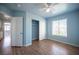 This bedroom features wood-look flooring, closet with sliding doors, and window for ample natural light at 6524 Rain Forest Dr, Las Vegas, NV 89108