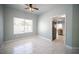 Open dining room featuring bright tile flooring, a ceiling fan, and large window at 6524 Rain Forest Dr, Las Vegas, NV 89108