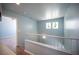 Upstairs hallway with wood floors and a staircase view to the living area at 6524 Rain Forest Dr, Las Vegas, NV 89108