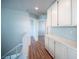 Upstairs hallway featuring wood floors and white cabinets for ample storage at 6524 Rain Forest Dr, Las Vegas, NV 89108