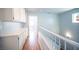 Hallway with wood floors, white cabinets, and a view to a bedroom at 6524 Rain Forest Dr, Las Vegas, NV 89108