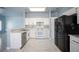 Updated kitchen with white cabinets, modern appliances, and stylish backsplash and marble floors at 6524 Rain Forest Dr, Las Vegas, NV 89108