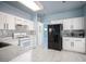 Well-lit kitchen with white cabinets, stainless steel appliances, and tile flooring at 6524 Rain Forest Dr, Las Vegas, NV 89108