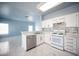 Modern kitchen featuring stainless steel appliances, white cabinetry, and a mosaic tile backsplash at 6524 Rain Forest Dr, Las Vegas, NV 89108