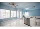Bright kitchen area with stainless steel appliances, large windows, and marble floors at 6524 Rain Forest Dr, Las Vegas, NV 89108