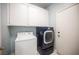 Laundry room featuring a modern washer and dryer and cabinets at 6524 Rain Forest Dr, Las Vegas, NV 89108