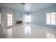 Bright living room featuring a fireplace, white-tiled floors, and access to the backyard at 6524 Rain Forest Dr, Las Vegas, NV 89108