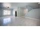 Spacious living room featuring marble floors and a staircase to the second floor at 6524 Rain Forest Dr, Las Vegas, NV 89108