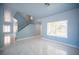 Open living space with bright tile flooring, staircase, and lots of natural light at 6524 Rain Forest Dr, Las Vegas, NV 89108