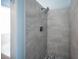The bathroom features a stand-up shower with gray tiling and river rock flooring at 6524 Rain Forest Dr, Las Vegas, NV 89108