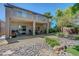 Backyard featuring a covered patio, lush landscaping, and decorative rock features at 68 Vista Del Mar St, Henderson, NV 89012